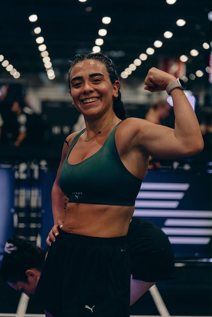 Lynn smiling and flexing her arm at a Hyrox event